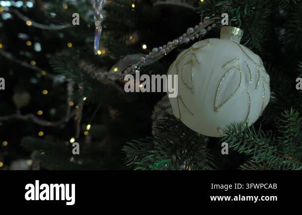 Close up elegant white Christmas ball with gold pattern hanging on ...