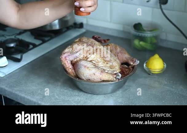 Pepper Hd hands sprinkling pepper over raw chicken, preparing poultry with spices ...