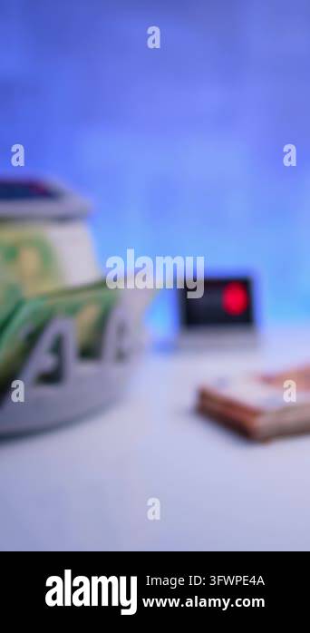 Stack of green banknotes places to a cash counting machine. Hand takes ...