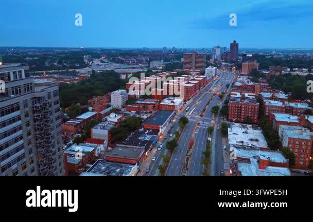 Sunset Time Frame Wide street with multi-lane highway along the urban neighborhoods with ...