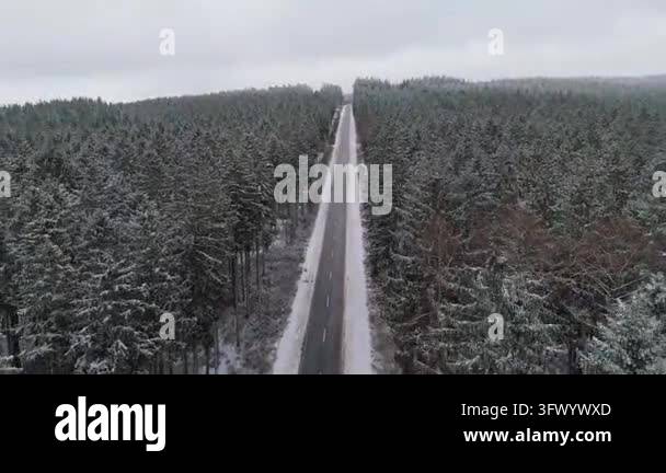 Snow In Athens Forest road in snow, aerial view, highway with coniferous trees ...