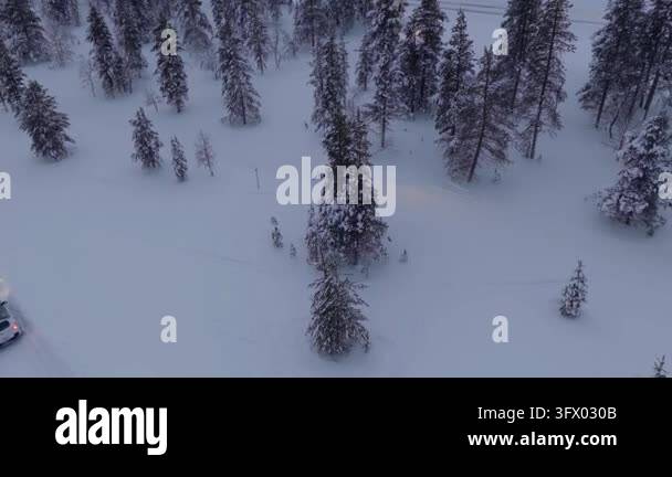 Snow In Athens Near-static hovering view over snow-covered taiga forest with a ...