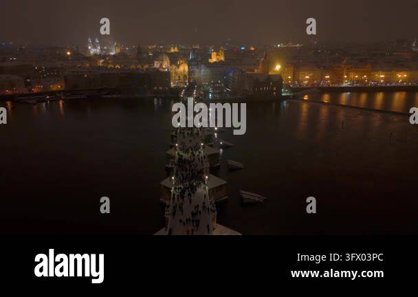 Snow In Athens Aerial view of a crowded bridge at night with snow falling and city ...