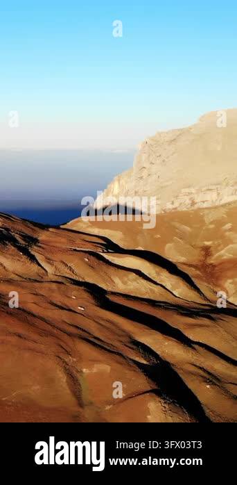 Wide natural landscape showing a barren rocky slope with scattered ...