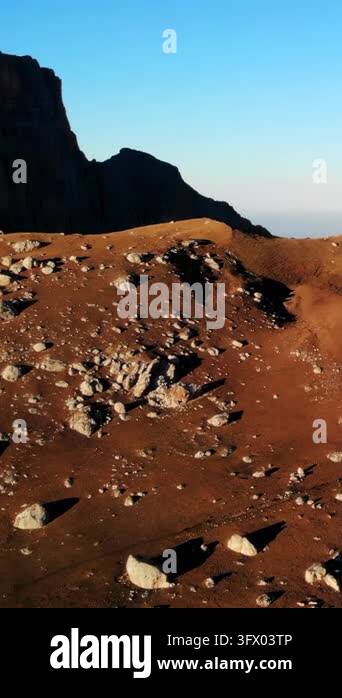 Wide natural landscape showing a barren rocky slope with scattered ...