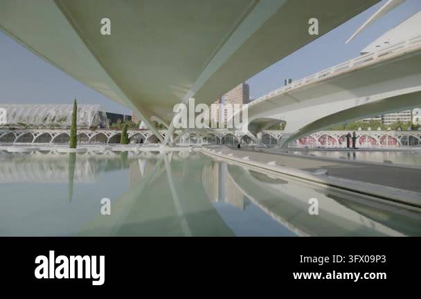 Low-angle view under sweeping modern concrete bridges with curved ...