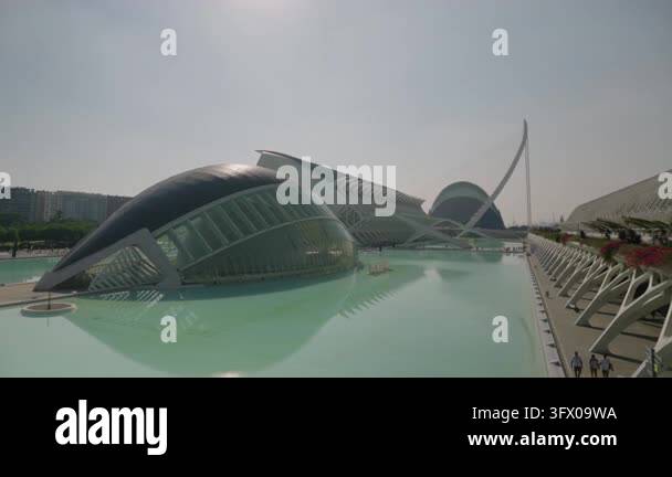 Modern waterfront complex with futuristic white curving buildings and ...