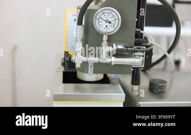 Small Lab Work Bench Close-up of industrial pressure gauge and stainless steel piping on lab ...
