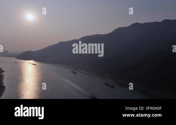 Sunset over mountains and calm water Stock Video Footage - Alamy