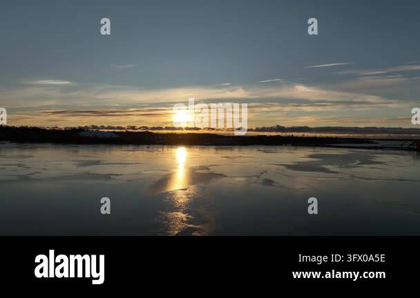 Sunset reflecting on calm water surface Stock Video Footage - Alamy