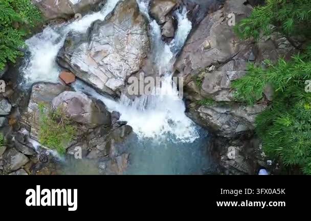 Aerial view of water cascading over rocks in a natural landscape Stock ...