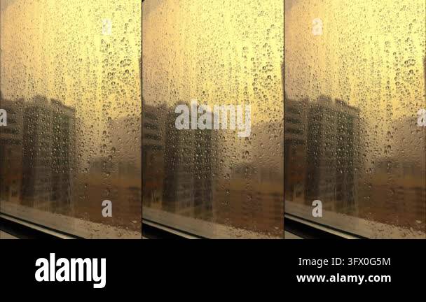 Rain falling on window in skyscraper apartment. Dark and stormy rainy ...