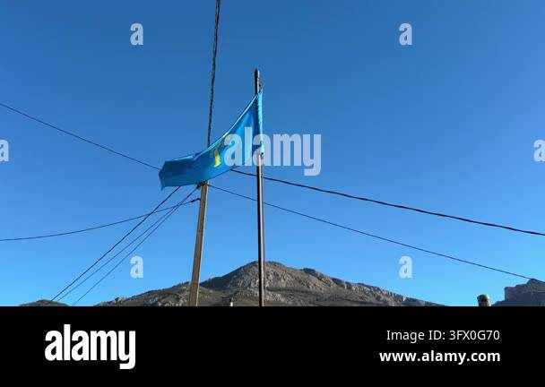 Asturian Flag Flying Above a Mountain Landscape Stock Video Footage - Alamy