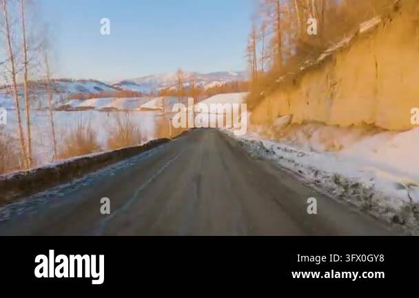Point of view shot of a car driving along a winding mountain road near ...