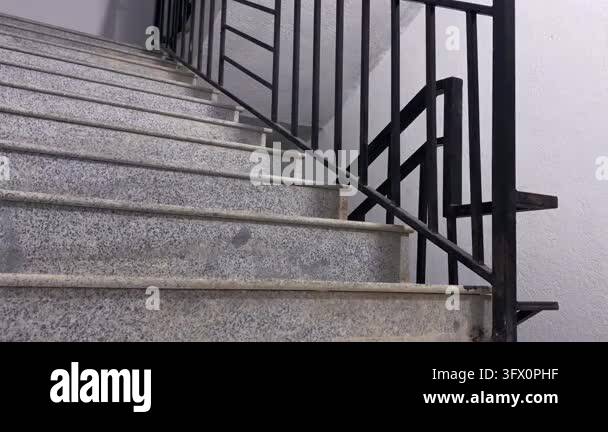 Person climbing stairs two steps at a time, low rear view, for mountain ...