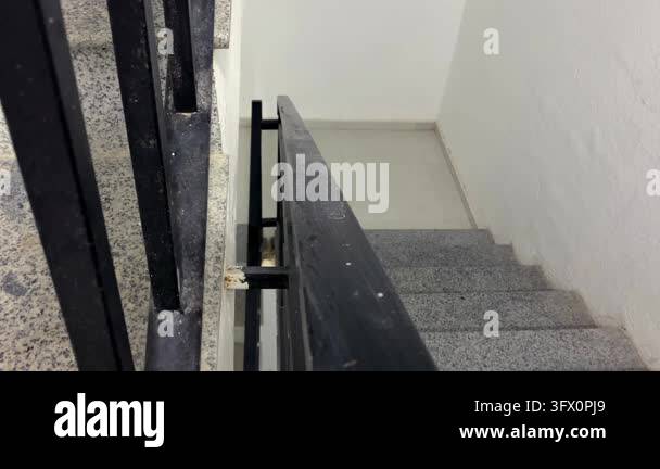 Person descending staircase, high angle rear view in residential ...