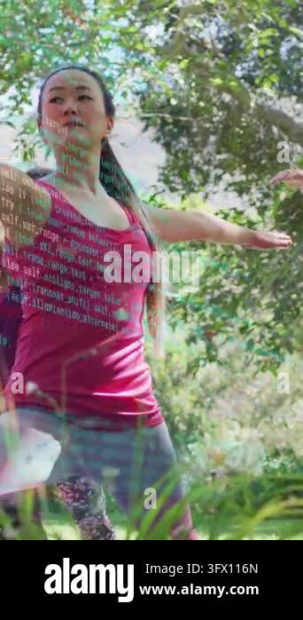 Vertical video: Woman yoga coach stepping to warrior, leading class ...