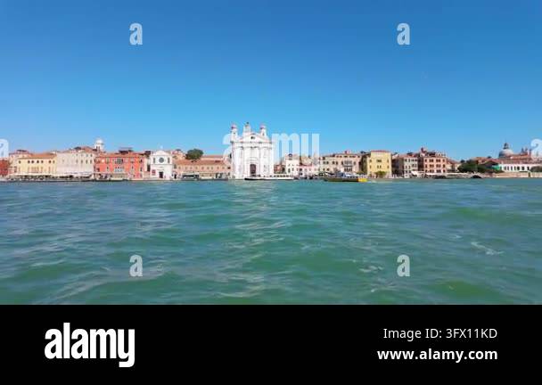 The camera holds a wide view across Venice?s waterway as colorful ...