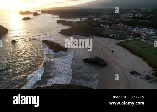 Elevated view of a secluded cove with limestone cliffs, turquoise waves ...