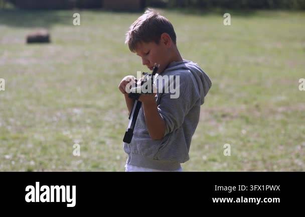 He Smiling Vector A boy plays soldier: he holds a real assault rifle and aims at a target ...