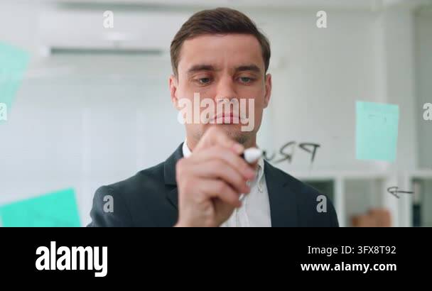 Caucasian businessman writes Protect word on glass board during office ...