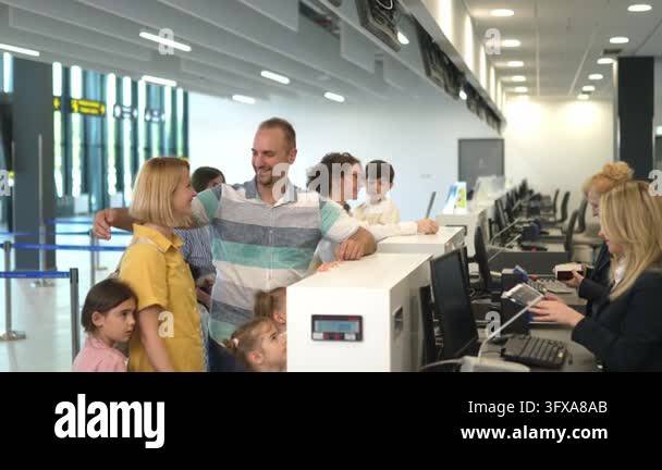 Family with children is completing the check-in and passport control ...