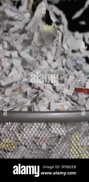 Paper Machine Hd Shredded paper falls from a machine into a basket. The slow motion ...