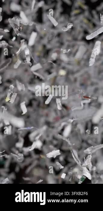 Frame Gray Texture Abstract close-up of shredded paper strips falling downward in ultra ...