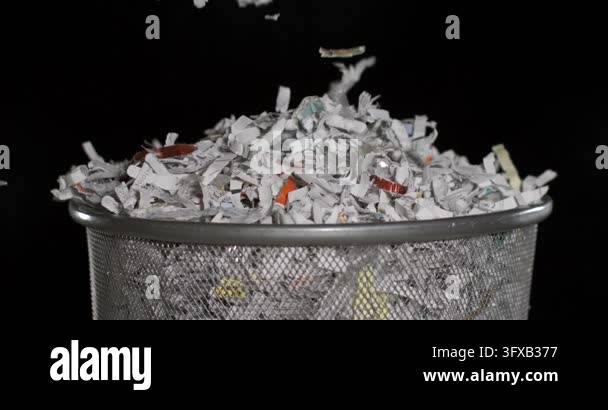 Scatterd Paper Files Shredded paper flies out of a basket. The slow motion highlights the ...