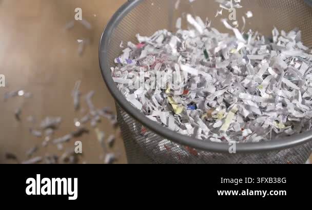 Scatterd Paper Files Shredded paper is lifted and scattered from a basket. The movement ...