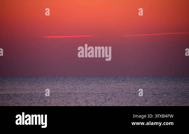 Sundet Line Model The view showcases a sunset over the ocean. Warm oranges and reds ...