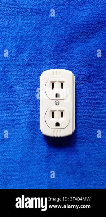 Electrical Isolation Image Close up top view of a white plastic duplex electrical outlet adapter ...