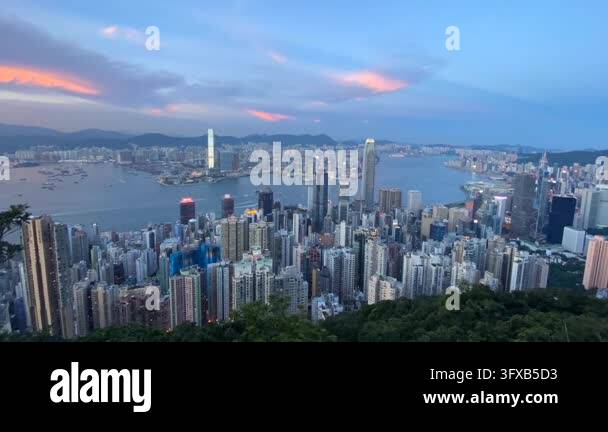 Sunset Time Frame Time lapse of a sprawling cityscape and harbor at dusk, with lights ...
