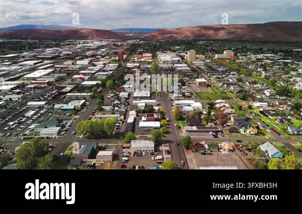 Aerial drone view gliding over city streets rooftops commercial ...