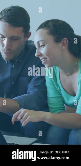 Animation of envelope icons over caucasian couple using laptop. Global ...