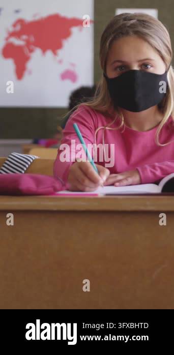 Animation of school items icons moving over schoolchildren wearing face ...