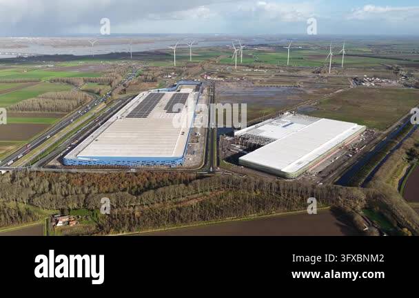 Three Large Warehouse Vector Aerial view of a large industrial warehouse and wind farm Stock Video ...
