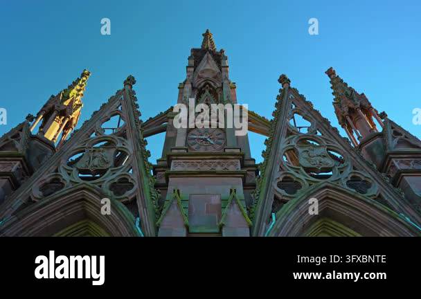 Pointed gables frame the central pinnacle of a Gothic cemetery gate ...