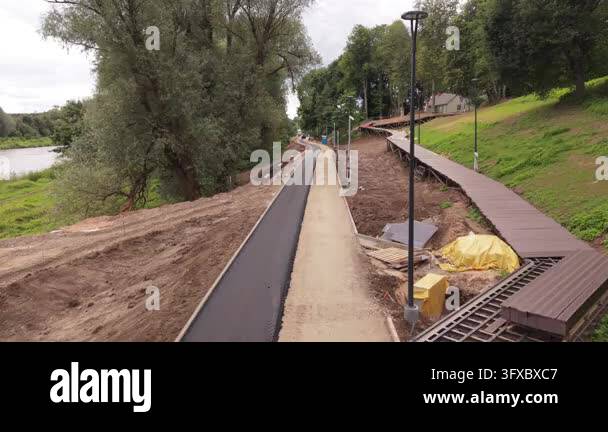 Earthwork Contracting Valmiera, Latvia - September 08, 2026: Drone footage follows asphalt ...