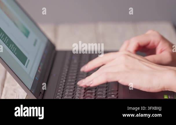 Close-up of female hands typing on a laptop keyboard. Concept of ...