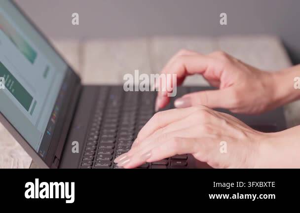 Close-up of female hands typing on a laptop keyboard. Concept of ...