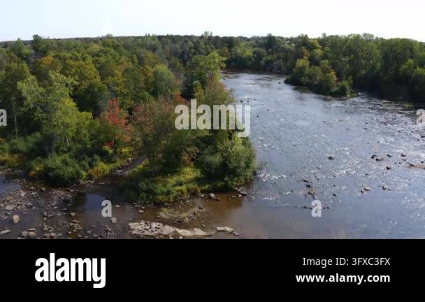 Rocky Stream Vector 4K aerial drone footage flying over a shallow rocky river in Saint ...