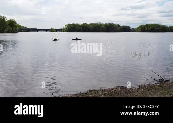 Background For Creative Form Scenic drone footage of two kayakers paddling across calm water in ...