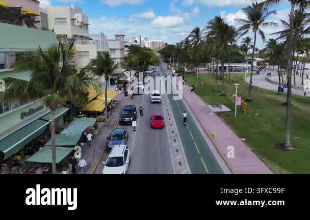 Aerial view following cars and people on the iconic ocean drive in ...