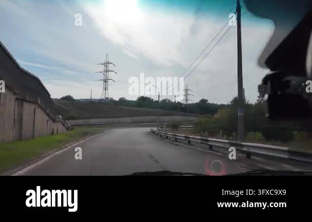 First-person POV walking along a narrow rural dirt road between garden ...