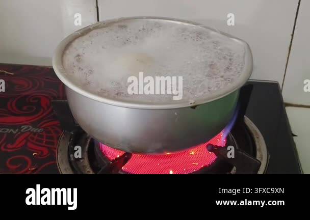 Boiling liquid in a metal pot on a red hot electric stove Stock Video ...