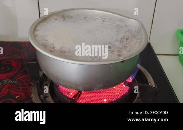 Boiling liquid in a metal pot on a red hot electric stove Stock Video ...