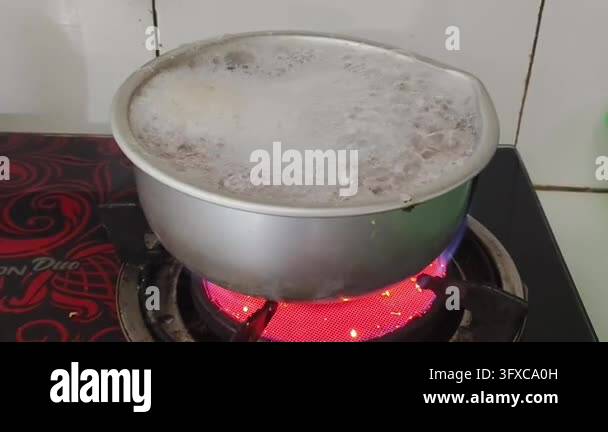 Boiling liquid in a metal pot on a red hot electric stove Stock Video ...