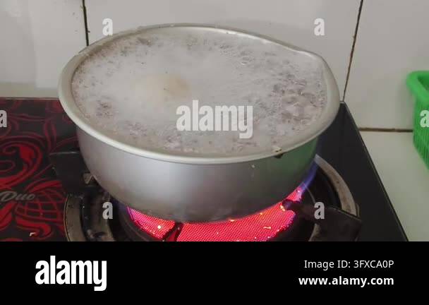 Boiling liquid in a metal pot on a red hot electric stove Stock Video ...