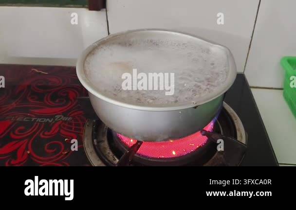 Boiling liquid in a metal pot on a red hot electric stove Stock Video ...